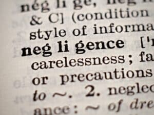 Dictionary definition of word negligence, selective focus.