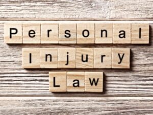personal injury law word written on wood block. personal injury law text on table, concept.