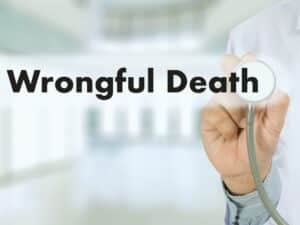 doctor holding a stethoscope with words wrongful death printed. concept of wrongful death settlement