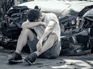 desperate man after car crash. concept of Can a Passenger Be Liable for a Car Accident in Nevada