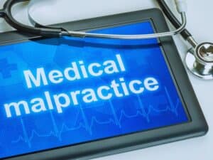Tablet with the text Medical malpractice on the display. Changes to Nevada Medical Malpractice Claims With AB404 concept