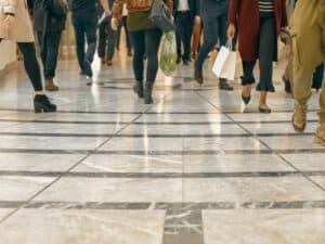 A modern floor with legs of a crowd walking in a shopping mall in the background. Concept of Top Causes of Personal Injury Accidents on the Strip