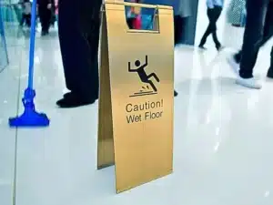 cleaning in progress, and wet floor caution sign besides. premises liability claim