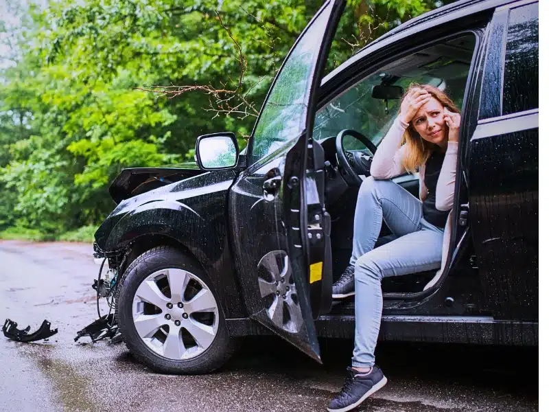Attorneys 9 woman is distressed in her crashed car on the road after not knowing what to do after a hit and run car accident.